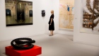 A visitor looks at various art installations on display during Art Basel Miami Beach in Miami, Flori