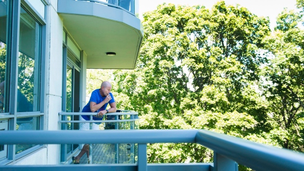 Gerald Major, 46, uses a vaporizer with medical marijuana on his back balcony at Oakville condo. 