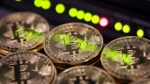 Stacks of bitcoins sit near green lights on a data cable terminal inside a communications room at an office in this arranged photograph in London, U.K., on Tuesday, Sept. 5, 2017. Bitcoin steadied after its biggest drop since June as investors and speculators reappraised the outlook for initial coin offerings. 