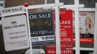 Real estate for sale signs are shown in Oakville, Ont., Dec. 1, 2018