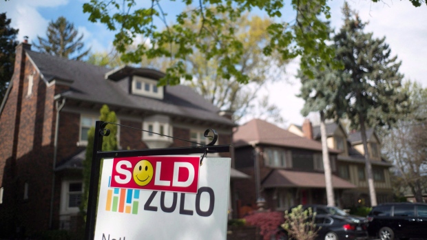 A sold sign is shown in front of west-end Toronto homes Sunday, May 14, 2017. 