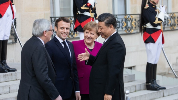 From left, Jean-Claude Juncker, Emmanuel Macron, and Angela Merkel, greet Xi Jinping, in Paris, on March 26. Photographer: Christophe Morin/Bloomberg