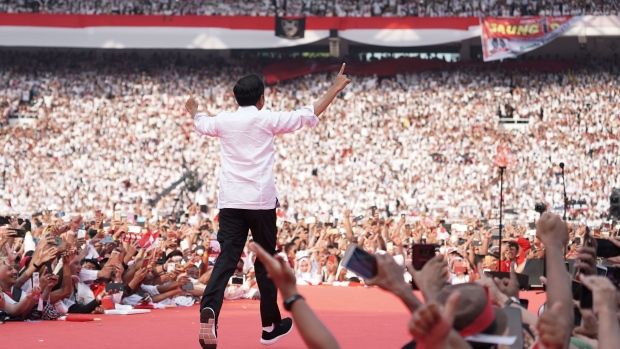 Joko Widodo, Indonesia's president, greets his supporters during a campaign rally in Jakarta, Indonesia, on Saturday, April 13, 2019. Voters go to the polls on April 17 in a contest that pits Widodo, a onetime furniture exporter known as Jokowi, against Prabowo Subianto, a general from the Suharto era. 