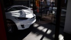 A Tesla Model X electric vehicle sits inside of a closed Tesla Inc. store in Palm Desert, California, U.S., on Thursday, March 7, 2019