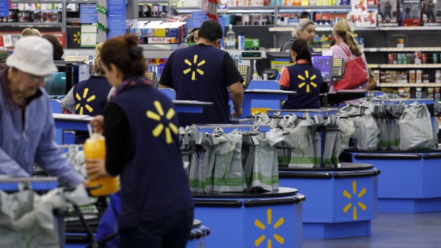 Cashiers ring up shoppers at a Walmart Inc. store in Burbank, California. 