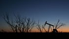 The silhouette of a pumpjack is seen at dusk in the Permian Basin near Midland, Texas, U.S., on Friday, March 2, 2018. Chevron, the world's third-largest publicly traded oil producer, is spending $3.3 billion this year in the Permian and an additional $1 billion in other shale basins. Its expansion will further bolster U.S. oil output, which already exceeds 10 million barrels a day, surpassing the record set in 1970. 