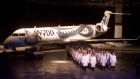 Employees march out the new Bombardier CRJ700 during roll out ceremonies, May 28, 1999, Montreal