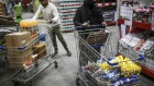 Customers with shopping carts browse products at a Walmart Inc. Bloomberg
