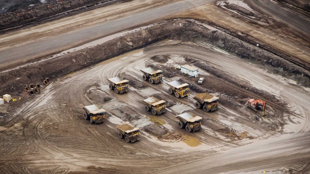 Heavy haulers sit parked at the Suncor Energy Inc. Millennium mine in this aerial photograph taken above the Athabasca oil sands near Fort McMurray, Alberta, Canada, on Monday, Sept. 10, 2018. 