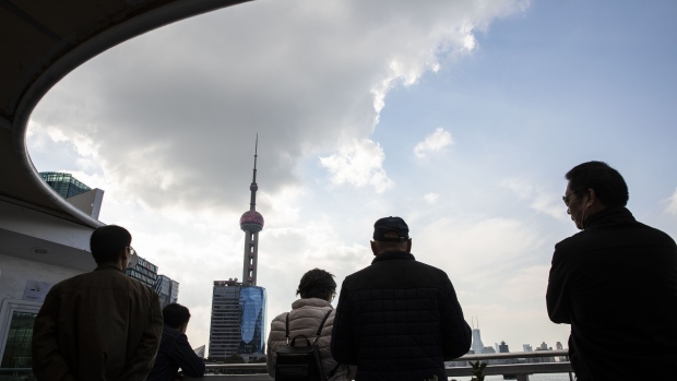 Passengers ride on a ferry as it travels past the Oriental Pearl Tower the Pudong Lujiazui Financial District in Shanghai, China, on Tuesday, Nov. 13. 2018. Some Chinese banks are struggling to comply with unprecedented regulatory targets for credit to private companies because they aren’t sure who to lend to, a sign that authorities' urgency to reverse an economic slowdown is muddying policy. 