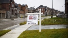 A "For Sale" sign stands in front of homes in East Gwillimbury, Ontario, Nov. 2, 2018.