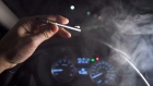 In this photo illustration, vapor from a cannabis oil vaporizer is seen as the driver is behind the 