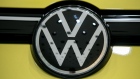 The updated Volkswagen AG (VW) badge sits on a VW Golf 8 hybrid automobile in a showroom at the automaker's headquarters in Wolfsburg, Germany, on Wednesday, Oct. 30, 2019. Volkswagen lowered its outlook for vehicle deliveries this year on a faster-than-expected decline in auto markets around the world amid economic jitters in Europe and an unprecedented slump in China. 