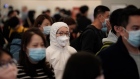 Passengers wear face masks at the departure hall of the high speed train station in Hong Kong