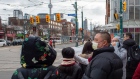 Pedestrians wear protective masks as they walk in Toronto on Monday, January 27, 2020. The Canadian 