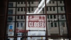 A "closed" sign hangs on the door of Lafayette Coney Island restaurant in Detroit, Michigan, U.S., on Saturday, April 4, 2020. 
