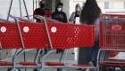 Customers wearing protective masks enter a Target Corp. store in Lawndale, California, U.S., on Monday, April 20, 2020.