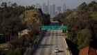 A vehicle drives along the nearly empty 110 freeway in Los Angeles, California, U.S., on Wednesday, April 1, 2020. The U.S. West Coast is offering hopeful signs that early social distancing efforts worked, allowing officials to increase hospital capacity and slowing the spread of the novel coronavirus. Photographer: Patrick T. Fallon/Bloomberg
