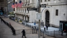A pedestrian passes the the New York Stock Exchange (NYSE) in New York, U.S., on Wednesday, June 17