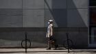 A pedestrian wearing a protective mask walks down Bank St. in Ottawa, Ontario, Canada, on Wednesday,
