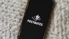 Postmates Inc. signage is displayed on a smartphone in an arranged photograph taken in the Brooklyn borough of New York, U.S., on Wednesday, July 1, 2020. Uber Technologies Inc. is in talks to purchase Postmates Inc., said a person familiar with the discussions, seeking to expand food delivery services in the U.S. and capitalize on a surge in orders during the coronavirus pandemic.