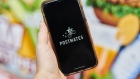 Postmates Inc. signage is displayed on a smartphone in an arranged photograph taken in the Brooklyn borough of New York, U.S., on Tuesday, June 30, 2020. Uber Technologies Inc. is in talks to purchase Postmates Inc., said a person familiar with the discussions, seeking to expand food delivery services in the U.S. and capitalize on a surge in orders during the coronavirus pandemic. Photographer. Gabby Jones/Bloomberg Photographer: Gabby Jones/Bloomberg