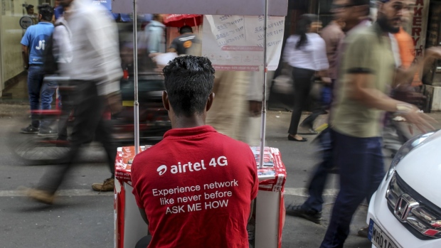 A Bharti Airtel Ltd. employee waits for customers at a street stall in Mumbai, India, on Monday, Feb. 3, 2020. Indian Prime Minister Narendra Modi’s government plans to allow foreign investors greater access to short-term and long-term government securities in a bid to tap money being poured into passive funds operated by firms such as BlackRock Inc.