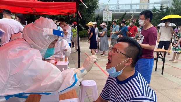 A health worker carrying out a COVID-19 test in Dalian on July 26. 