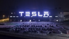 The Tesla Inc. Gigafactory stands illuminated at night in Shanghai.