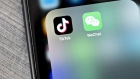 The Tencent Holdings Ltd. WeChat and ByteDance Ltd. TikTok app icons are displayed on a smartphone in an arranged photograph taken in Arlington, Virginia, U.S., on Friday, Aug. 7, 2020. President Donald Trump signed a pair of executive orders prohibiting U.S. residents from doing business with the Chinese-owned TikTok and WeChat apps beginning 45 days from now, citing the national security risk of leaving Americans' personal data exposed.