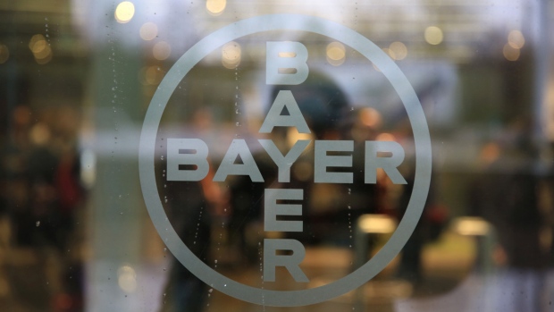 The Bayer AG logo sits on a glass panel inside the Bayer communications center at the drugmaker's headquarters in Leverkusen, Germany, on Wednesday, Feb. 22, 2017. Demand for medicines such as the blood thinner Xarelto and the eye treatment Eylea boosted sales and profit. Photographer: Krisztian Bocsi/Bloomberg