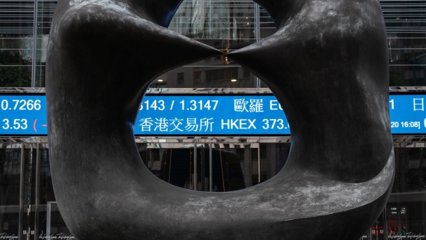 An electronic ticker displaying the share price of Hong Kong Exchanges & Clearing Ltd. (HKEX) is seen through a sculpture at the Exchange Square complex in Hong Kong, China, on Wednesday, Aug. 19, 2020. HKEX posted a 1% gain in profit, benefiting from a spate of high-profile Chinese stock listings and a pick up in trading as the pandemic and political tensions stoked volatility. Photographer: Roy Liu/Bloomberg