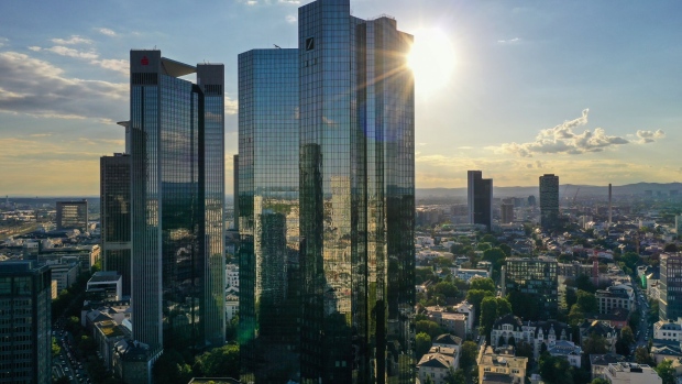 Sunlight reflects off the Deutsche Bank AG twin tower headquarters, right, beside the Frankfurter Sparkasse Tower on the financial district skyline in Frankfurt, Germany, on Wednesday, Sept. 2, 2020. Partly thanks to the government’s stimulus program, German activity has staged a strong rebound after collapsing in the second quarter, and companies have turned slightly more optimistic that it will continue to accelerate into next year.