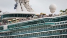 Passengers stand on board the Royal Caribbean Cruises Ltd. Navigator Of The Seas cruise ship at the Port of Miami in Miami, Florida, U.S., on Monday, March 9, 2020. At the world's busiest cruise port, thousands of vacationers paid little heed to a government warning that Americans should avoid setting sail on the massive ships.