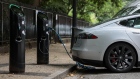 A charging plugs connects a Tesla Inc. Model S electric vehicle (EV) to a charging station in London, U.K., on Friday, Aug. 4, 2017. The U.K. government plans to invest more than 800 million pounds ($1 billion) in new driverless and zero-emission vehicle technology as it seeks to boost its economy while leaving the European Union.