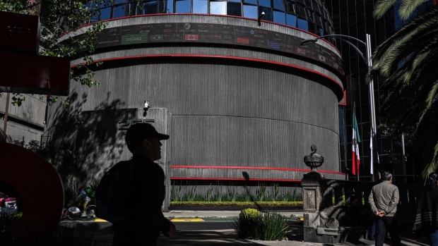 Pedestrians pass in front of the Bolsa Mexicana de Valores SAB, Mexico's stock exchange, in Mexico City, Mexico, on Monday, Dec. 3, 2018. Mexican airport bonds rallied after the government said it will buy back a portion of debt sold to finance the now-scrapped $13 billion project, suggesting a more market-friendly approach from newly inaugurated President Andres Manuel Lopez Obrador. The Mexican Bolsa IPC index rose 1.1 percent at 42,174.03 in Mexico City.