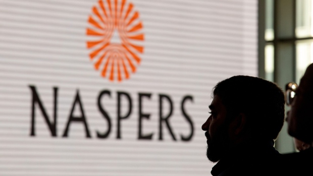 A Naspers Ltd. logo is displayed on a large electronic screen during the company's extraordinary general meeting in Cape Town, South Africa on Friday, Aug. 23, 2019. Africa’s largest company by market value is creating a new entity called Prosus NV to hold assets including a 31% stake in Chinese internet giant Tencent Holdings Ltd. that’s worth about $125 billion.