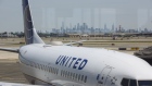 The Manhattan skyline stands past a United Airlines Holdings Inc. airplane on the tarmac at Newark International Airport (EWR) in Newark, New Jersey, U.S., on Tuesday, June 9, 2020. Airline losses are surging to unprecedented levels expected to be more than three times those following the 2008 global economic slump, according to the industry's main trade group.