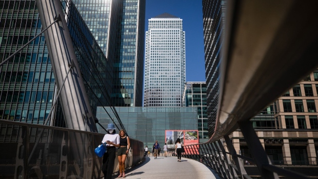 Pedestrians pass along a walkway in the Canary Wharf business, financial and shopping district of London, U.K., on Monday, Sept. 14, 2020. Londoners are steadily increasing their use of public transport after schools reopened, freeing parents to go back to the workplace. Photographer: Simon Dawson/Bloomberg