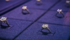 Diamond rings are displayed in a cabinet inside a De Beers SA store in Hong Kong. Photographer: Calvin Sit/Bloomberg
