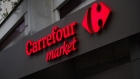 A logo outside a Carrefour Market supermarket, operated by Carrefour SA, in Paris, France, on Wednesday, Jan. 13, 2021. Alimentation Couche-Tard Inc., the Canadian convenience-store operator that owns the Circle K chain, is exploring a takeover of French grocer Carrefour SA, a deal that would create a trans-Atlantic retail giant. Photographer: Nathan Laine/Bloomberg