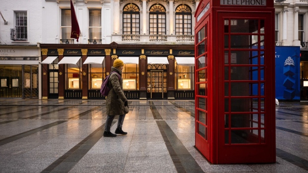 A pedestrian passes empty displays at a closed Cartier luxury watches and jewelry store in London, U.K., on Wednesday, Jan. 20, 2021. Richemont's Christmas-quarter sales got a boost from high-spending consumers in China who bought more on their home turf as they avoided trips abroad due to Covid-19. Photographer: Simon Dawson/Bloomberg