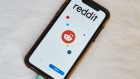 Reddit Inc. signage is displayed on a smartphone in an arranged photograph taken in the Brooklyn borough of New York, U.S., on Tuesday, June 30, 2020. Twitch and Reddit Inc. banned content linked to President Donald Trump for violating their rules against encouraging hate.