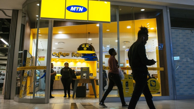 Pedestrians pass an MTN Group Ltd. telecommunications store at the Clearwater Mall in Johannesburg, South Africa, on Thursday, Aug. 3. 2017. MTN Group Ltd. said a Nigerian listing that it agreed to as part of a $1 billion regulatory fine was on track and would take place within the next six to 12 months.