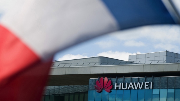 A French national flag hangs near the Huawei Technologies France SASU offices in Paris, France, on Tuesday, July 7, 2020. France's decision to give only temporary security approval for 5G mobile equipment shows the government intends to gradually sidelineHuawei Technologies Co., a majority party lawmaker said. Photographer: Nathan Laine/Bloomberg