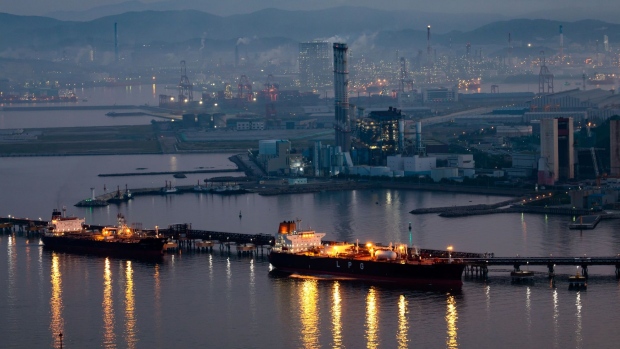 A liquefied petroleum gas (LPG) tanker, center right, sits moored at a port near SK Innovation Co.'s Ulsan Complex oil refinery facilities at dusk in Ulsan, South Korea, on Sunday, Aug. 4, 2019. Ulsan is known as Hyundai Town, an industrial powerhouse with the world’s largest car-assembly plant, its third-biggest oil refinery and the giant shipyards. Since 2016, some 35,000 workers quit or lost their jobs at the city's shipyard, in a downturn as dramatic as it was sudden.