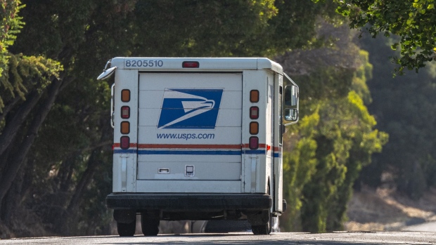 A U.S. Postal Service truck drives in Crockett, California, U.S., on Monday, Aug. 17, 2020. A pitched battle over the U.S. Postal Service and its ability to reliably deliver presidential election ballots during a pandemic has broken out on the eve of the parties' high-profile conventions