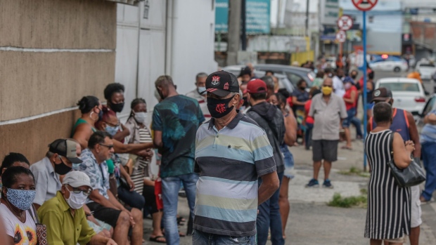 People wait in line to get vaccinated outside of a clinic in Rio de Janeiro.