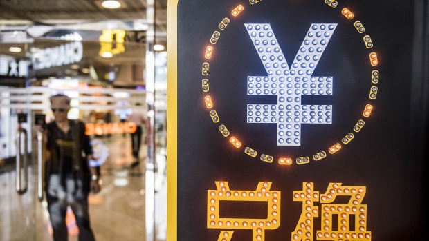The currency symbol for the Chinese yuan is displayed at a currency exchange store in Hong Kong, China, on Wednesday, Aug. 12, 2015. The yuan sank for a second day, spurring China's central bank to intervene as the biggest rout since 1994 tested the government's resolve to give market forces more sway in determining the exchange rate. Photographer: Bloomberg/Bloomberg