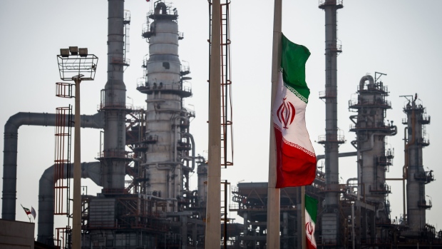 An Iranian national flag flies near gas condensate processing facilities in the new Phase 3 facility at the Persian Gulf Star Co. (PGSPC) refinery in Bandar Abbas, Iran. Photographer: Ali Mohammadi/Bloomberg